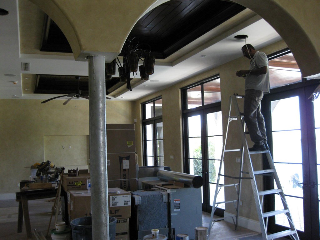 Technician installing automation equipment in a Duck Key residence